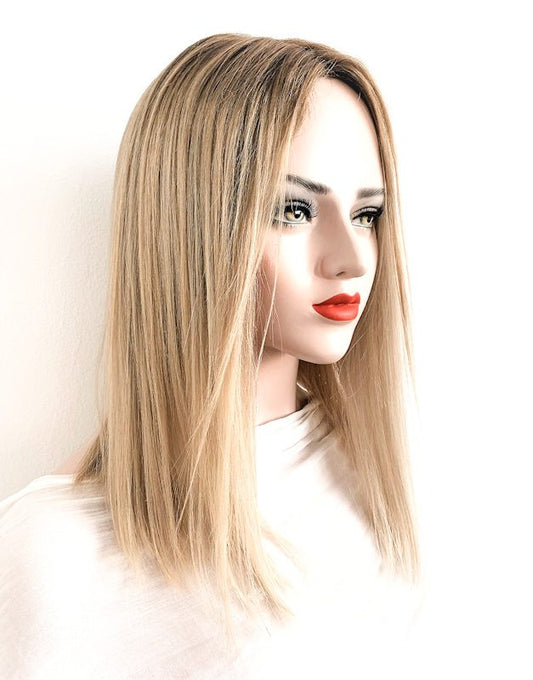 Blonde wig on a mannequin head with a white background